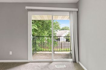 Living Area With Balcony at Spring Creek Townhomes Apartments, Springfield